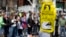Visitors pause at a makeshift memorial in Copley Square for victims of the Boston Marathon bombings, Apr. 27, 2013, in Boston, Mass.