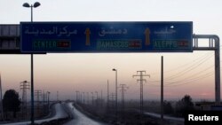 FILE - A general view shows a deserted road that leads to Deir el-Zour, Oct. 22, 2013. 