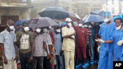 FILE: Family of victims of heavy flooding and mudslides in Regent wait to identify their bodies at Connaught hospital morgue in Sierra Leone, Freetown. Taken 8.16.2017