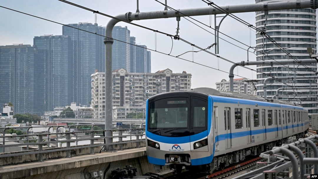 A train of the Line 1 of the HCMC Metro is seen past residential buildings in Ho Chi Minh City on Dec. 22, 2024.