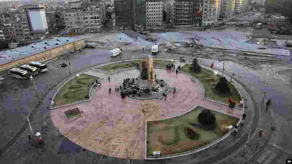 Police guard the monument of Mustafa Kemal Ataturk, founder of the modern Turkey, at the Taksim Square in Istanbul, Turkey, June 12, 2013.