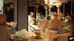 Medical personnel attend patients at Casalpalocco Covid 3 hospital in the outskirts of Rome, Jan. 1, 2021. 