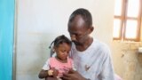 FILE-Man carries his daughter at a medical health center in Omdurman, Sudan, September 3, 2023. REUTERS/El Tayeb Siddig