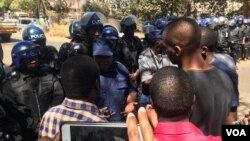 Doctors and police talking about protests in Harare following the abduction of Dr. Peter Magombeyi, leader of the Zimbabwe Hospital Doctors Association.