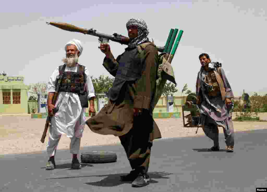 Former Mujahideen hold weapons to support Afghan forces in their fight against Taliban, on the outskirts of Herat province, July 10, 2021.