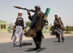 Former Mujahideen hold weapons to support Afghan forces in their fight against Taliban, on the outskirts of Herat province, July 10, 2021.