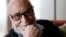 Belgian physicist Francois Englert poses in his home in Brussels, Oct. 8, 2012. 