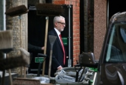Britain's opposition Labor Party leader Jeremy Corbyn leaves Islington Town Hall through the backdoor after a meeting following the results of the general election in London, Britain, Dec. 13, 2019.