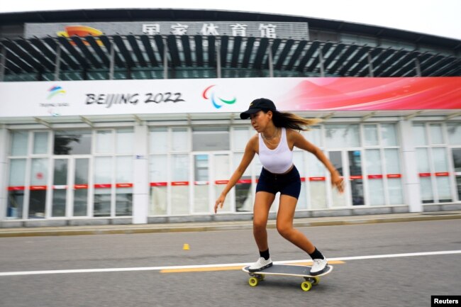 Duo Lan, 31, founder of Beijing Girls Surfskating Community, rides a skateboard during a free weekly training session, outside the National Sports Stadium in Beijing, China June 19, 2022. (REUTERS/Tingshu Wang)