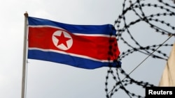 The North Korea flag flutters next to concertina wire at the North Korean embassy in Kuala Lumpur, Malaysia