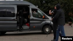 FILE - Law enforcement officers detain a journalist in central Minsk, Belarus, Aug. 27, 2020.