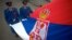 FILE - Serbian soldiers hold their country's flag in Belgrade. 