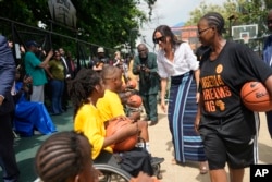 FILE—Meghan Markle, centrt, dpeaks with children on a wheelchair during the Giant of Africa Foundation at the Dream Big Basketball clinic in Lagos Nigeria, May 12, 2024.