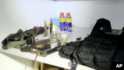 FILE —This image taken from a video released by the Israeli Defense Forces, November 15, 2023, shows a bullet proof vest with a Hamas insignia that was found along with weapons the IDF says were found in a medical closet at the MRI center at al-Shifa hospital in Gaza City.