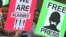 Des manifestants pour la liberté de la presse tiennent des pancartes devant le tribunal de première instance de Harare.