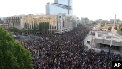 Protesters gather Tuesday, June 2, 2020 in Paris. Thousands of people defied a police ban and converged on the main Paris courthouse for a demonstration to show solidarity with U.S. protesters and denounce the death of a black man in French police custody