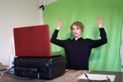 FILE - Lisa Wymore, a professor of dance, theater and performances studies at University of California, Berkeley leads warm-ups for an online course in Berkeley, California, March 12, 2020.