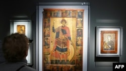 FILE—A visitor looks at "Vita Icon of Saint George with Scenes of His Passion and Miracles," while touring the "Africa & Byzantium" exhibit during a press preview at The Metropolitan Museum of Art in New York on November 16, 2023.