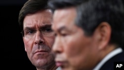Defense Secretary Mark Esper, left, listens as South Korean National Defense Minister Jeong Kyeong-doo, right, speaks during a news conference at Pentagon in Washington, Feb. 24, 2020.