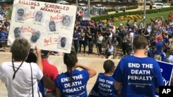 Protesters gather outside the state Capitol building, April 14, 2017, in Little Rock, Ark., to voice their opposition to Arkansas' seven upcoming executions. 
