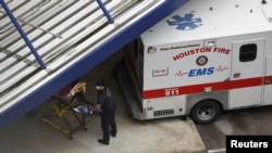 FILE - A patient is wheeled into Houston Methodist Hospital amid the global outbreak of the coronavirus disease (COVID-19), in Houston, Texas, June 22, 2020. 