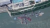 FILE - This satellite image from Planet Labs PBC shows what appears to be a sunken Chinese submarine at a shipyard near Wuhan, China, June 15, 2024.