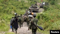 FILE - Congolese soldiers move to front line positions as they advance against the M23 rebels in Kibumba, north of Goma, Oct. 27, 2013. 