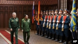 Russian Defense Minister Sergei Shoigu (L) and Commander-in-Chief of Myanmar's armed forces, Senior General Min Aung Hlaing walk past the honor guard prior to their talks in Moscow, June 22, 2021. (Vadim Savitskiy/Russian Defense Ministry Press Service)
