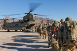 FILE -U.S. soldiers attached to the 101st Resolute Support Sustainment Brigade, Iowa National Guard and 10th Mountain, 2-14 Infantry Battalion, load onto a Chinook helicopter to head out on a mission in Afghanistan, Jan. 15, 2019. (Credit: U.S. Army)