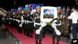 Cambodian military police officers carry coffins of Cambodian soldiers killed in Africa during the returning ceremony at Phnom Penh International Airport, in Phnom Penh, Cambodia, Sunday, May 21, 2017. Tears were shed and the sounds of cries were heard from the families of four Cambodian soldiers who were killed by a Christian rebel group in the Central African Republic earlier this month as the bodies arrived home Sunday. (AP Photo/Heng Sinith)