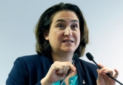 FILE - Barcelona mayor Ada Colau speaks at a mayors meeting in Paris, Oct. 23, 2017.
