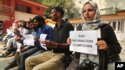 FILE - Kashmiri journalists display placards during a protest against the communication blackout in Srinagar, Indian controlled Kashmir, Oct. 3, 2019. 