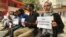 FILE - Kashmiri journalists display placards during a protest against the communication blackout in Srinagar, Indian controlled Kashmir, Oct. 3, 2019. 
