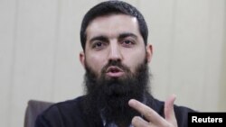 FILE- Halis Bayancuk, a Turkish cleric detained several times on suspicion of aiding al-Qaida, in Istanbul, Turkey, March 22, 2015. Bayancuk, 31, also known as Abu Hanzala, has cautioned Ankara against taking a more active role in the U.S.-led fight again