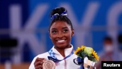 Bronze medalist Simone Biles of the United States celebrates on the podium, Aug.. 3, 20221. 