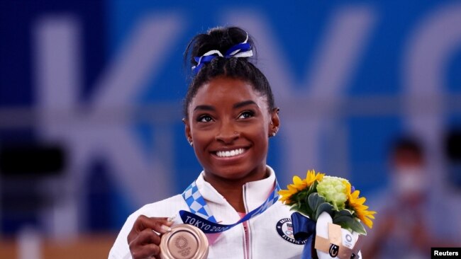 Bronze medalist Simone Biles of the United States celebrates on the podium, Aug.. 3, 20221.