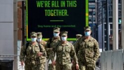 U.S. military personnel wearing face masks arrive at the Jacob K. Javits Convention Center, as the outbreak of the coronavirus disease (COVID-19) continues, in the Manhattan borough of New York City, April 7, 2020.
