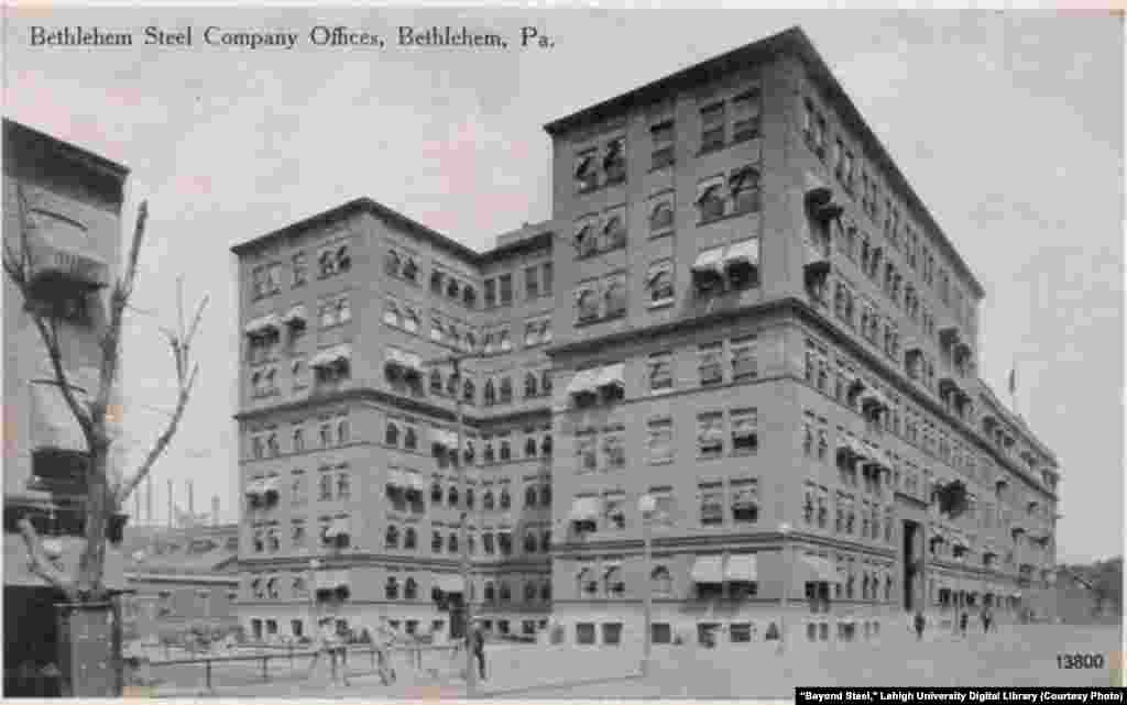 View of Bethlehem Steel offices with pedestrians in foreground and plant in background, Bethlehem, Pennsylvania, sometime between 1907-1914.