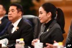 In this photo released by Thailand's Government Spokesman Office, Thailand's Prime Minister Paetongtarn Shinawatra, right, attends a meeting in Beijing, China, Feb. 6, 2025. (Thailand's Government Spokesman Office via AP)