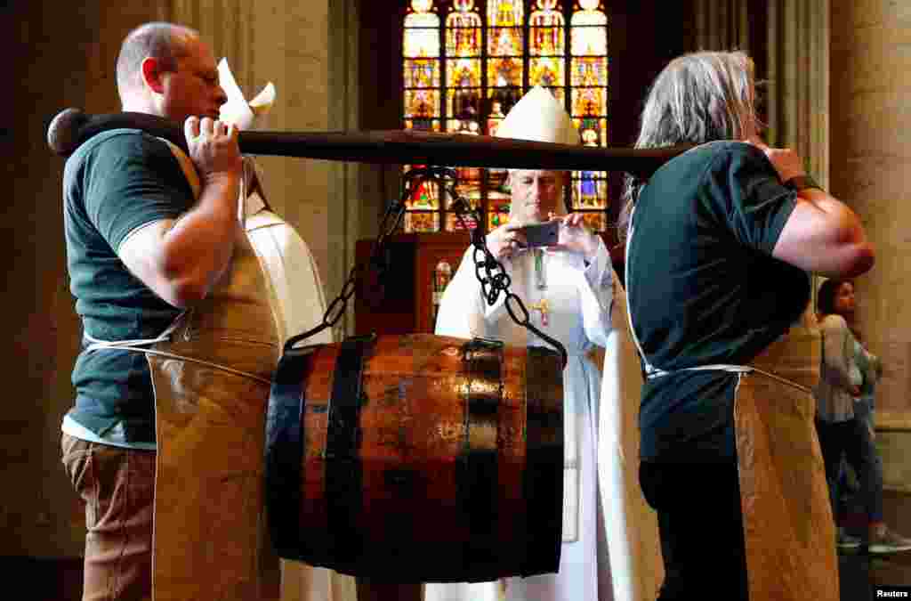 Bearers carry a barrel of beer ahead of a mass celebrating Saint-Arnould, patron saint of brewers, at Saint Gudula Cathedral in Brussels, Belgium.