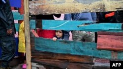 Un niño observa cómo los residentes son evacuados de sus hogares en medio de la llegada del huracán Iota, en Tegucigalpa, el 17 de noviembre de 2020.