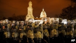 FILE - District of Columbia National Guard stand outside the Capitol, Jan. 6, 2021.