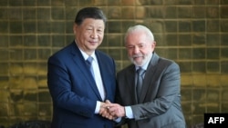 FILE - China's President Xi Jinping shakes hands with Brazil's President Luiz Inacio Lula da Silva aft  a gathering  astatine  Alvorada Palace successful  Brasilia connected  Nov. 20, 2024.