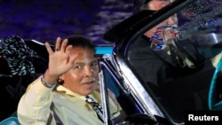 Boxing great Muhammad Ali waves to the crowd during the opening ceremony of the World Equestrian Games in Lexington, Kentucky, in this September 25, 2010 file photo.