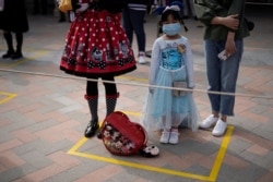 Visitors line up following social distancing markers at Shanghai Disney Resort as the Shanghai Disneyland theme park reopens following a shutdown due to the coronavirus disease (COVID-19) outbreak, in Shanghai, China, May 11, 2020.