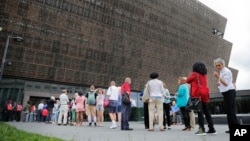 FILE - People wait in line to enter the Smithsonian National Museum of African American History and Cultural on the National Mall in Washington, May 1, 2017. On Wednesday, a noose, a symbol of racism in the U.S., was found on Smithsonian grounds, the second such incident this week.