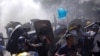 Anti-coup protesters discharge fire extinguishers to counter the tear gas fired by police during a demonstration in Naypyitaw, Myanmar, March 8, 2021. 