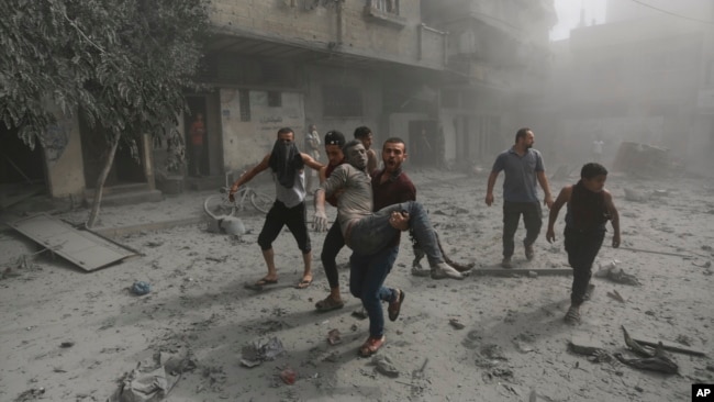 Palestinians evacuate a wounded man following Israeli airstrikes on Gaza City, Oct. 23, 2023.