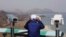 A South Korean tourist uses binocular to look at the Diamond Mountain in North Korea from the Unification Observation post in Goseong, South Korea, April 7, 2017. 