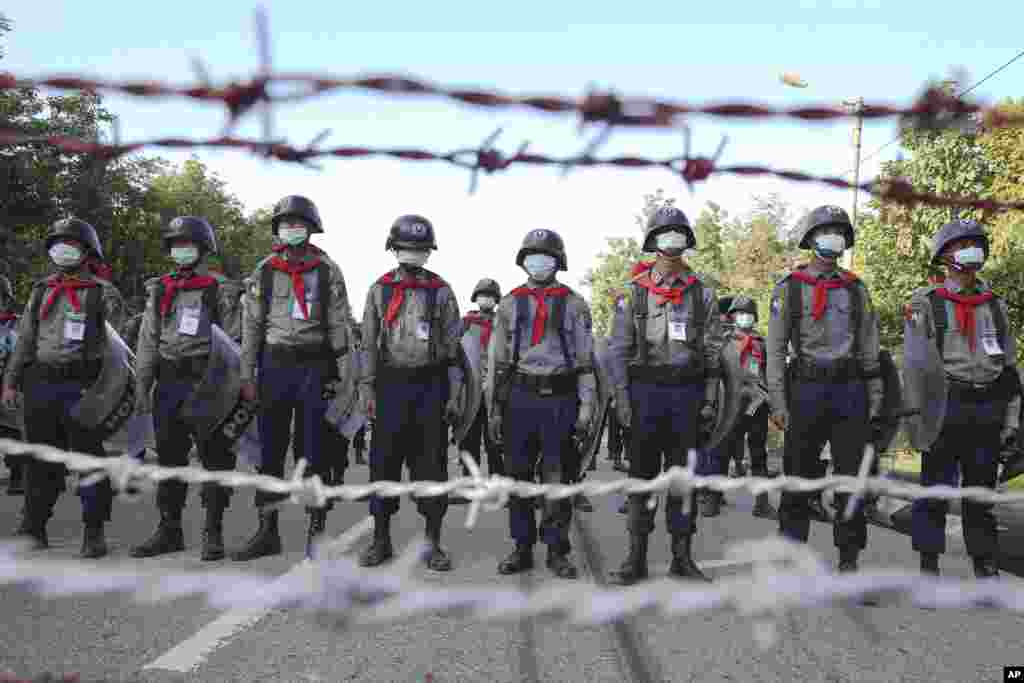 Police stand guard behind barbed wire as they attempt to stop protesters outside Union Election Commission office in Naypyitaw, Myanmar.&nbsp;The military-backed main opposition party said it rejected last Sunday&#39;s election results, citing unfairness.